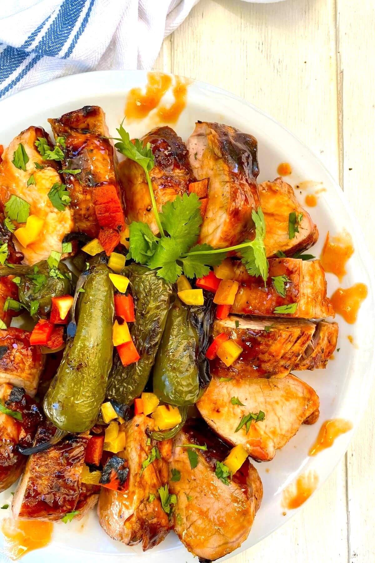 glazed pork tenderloin with grilled jalapeno peppers.