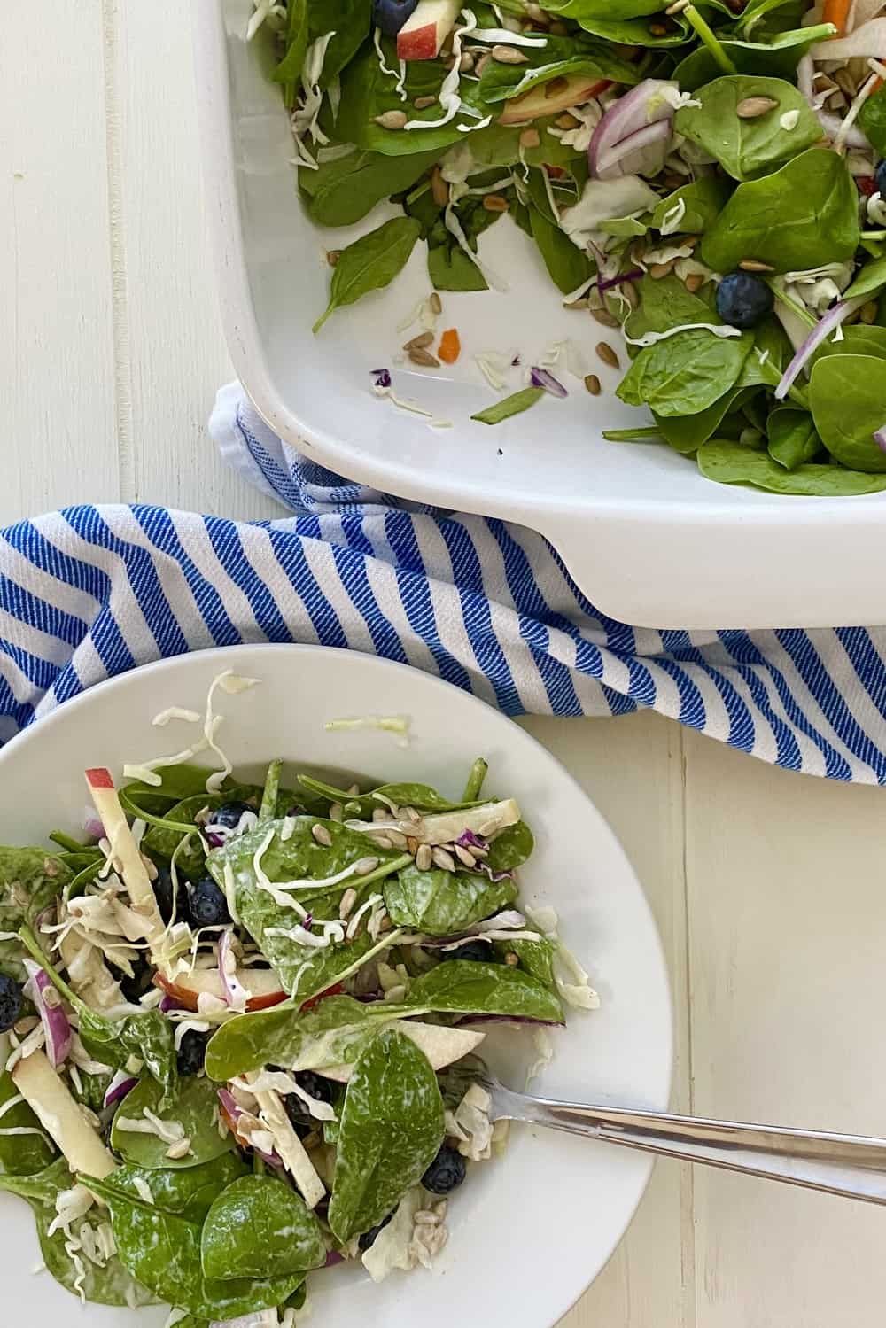 spinach blueberry salad in a bowl and serving dish