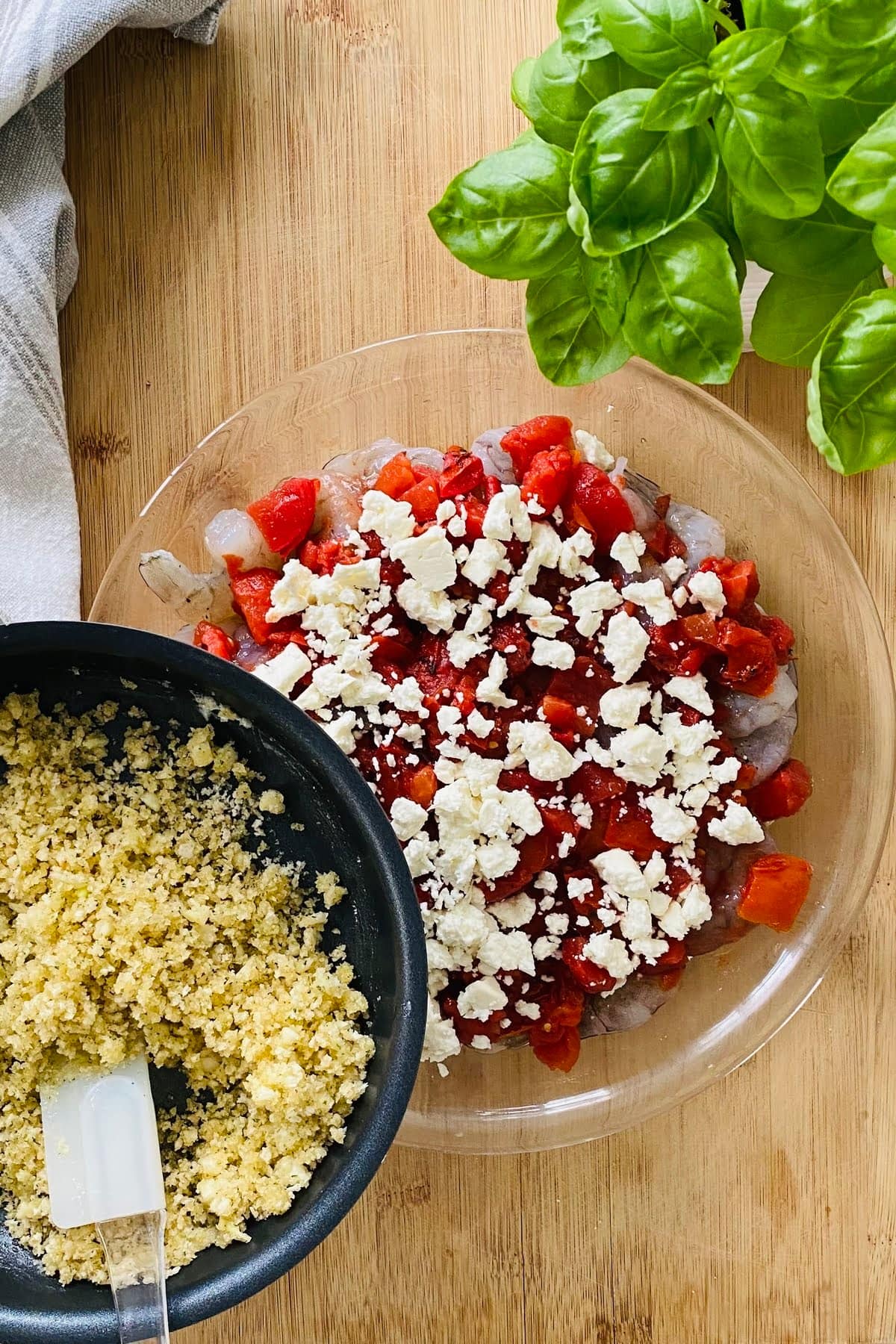 topping shrimp, tomatoes, and feta with garlic butter panko