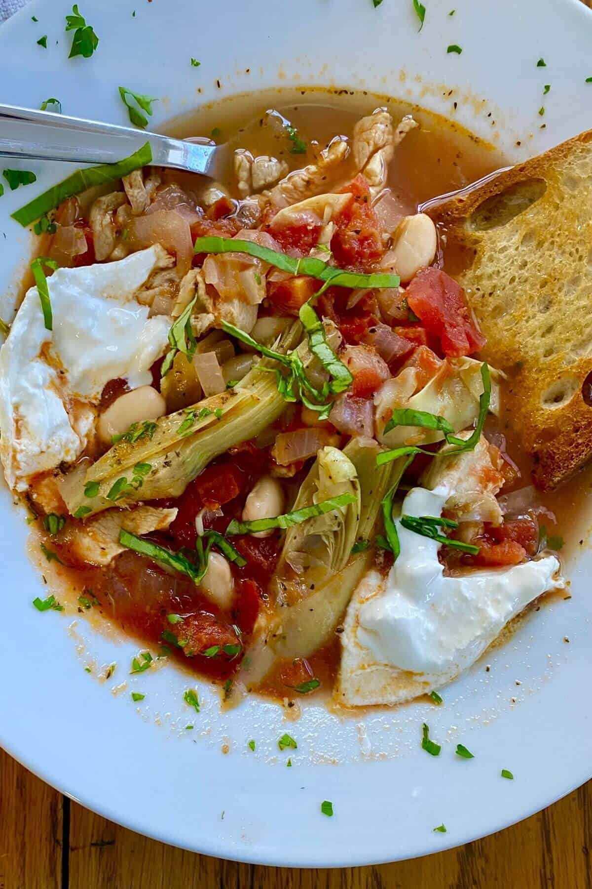 hearty bowl of Italian chicken soup with artichokes.