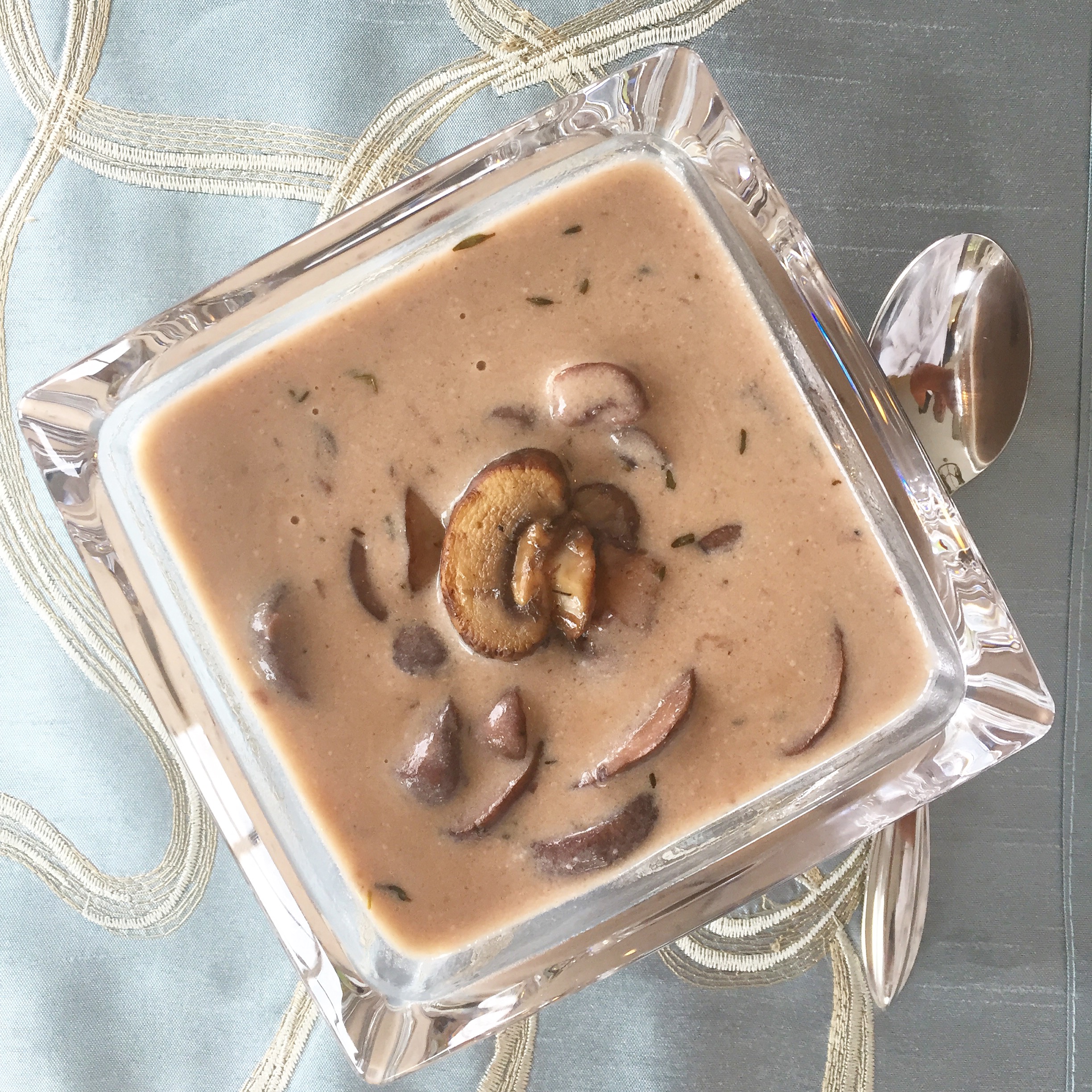 square glass bowl containing cream of mushroom soup