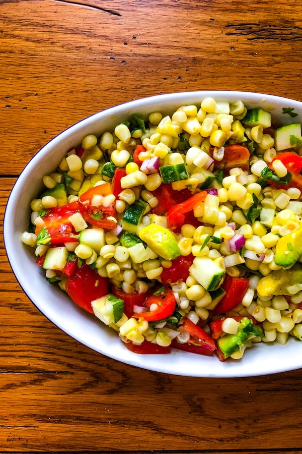 a side dish of summer produce with tomatoes and cucumbers