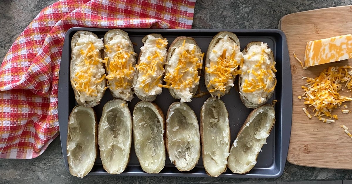 sheet pan of stuffed potatoes with cheddar cheese