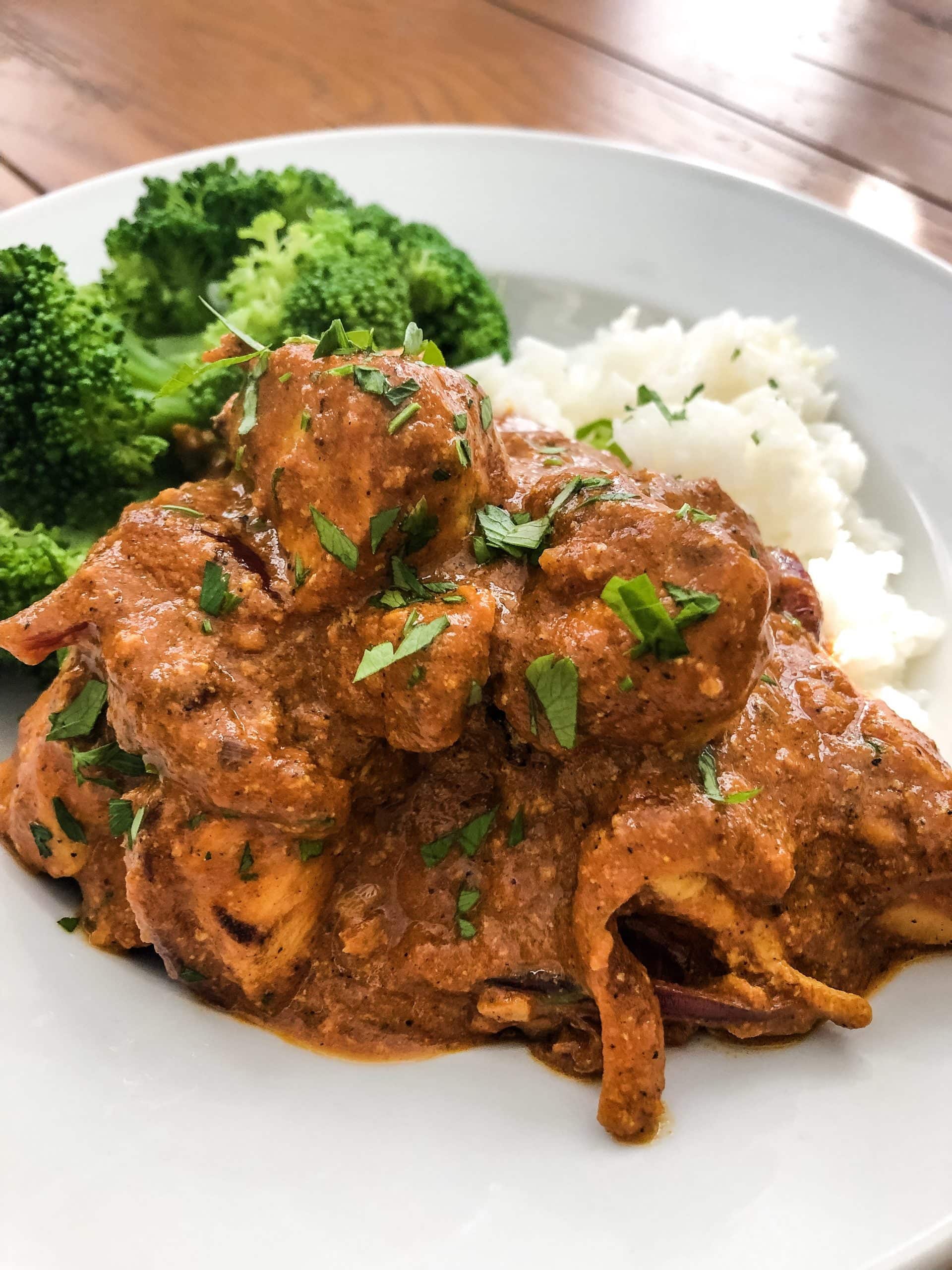Naan with butter chicken with basmati rice and steamed broccoli.