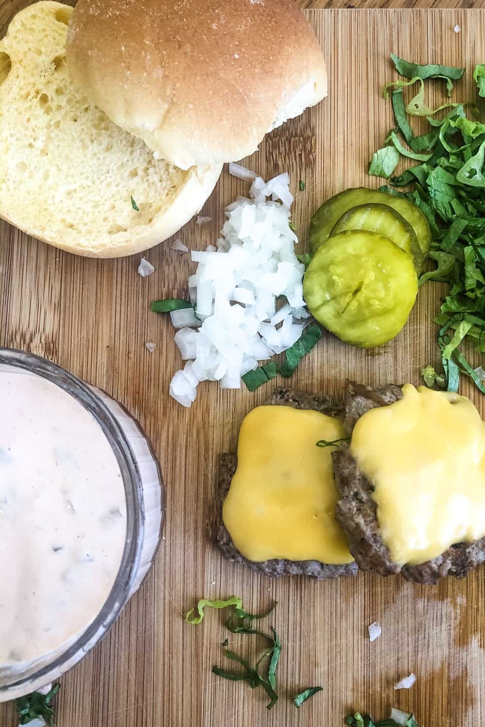 bun, special sauce, pickle chips, chopped onion, cheeseburgers, shredded lettuce