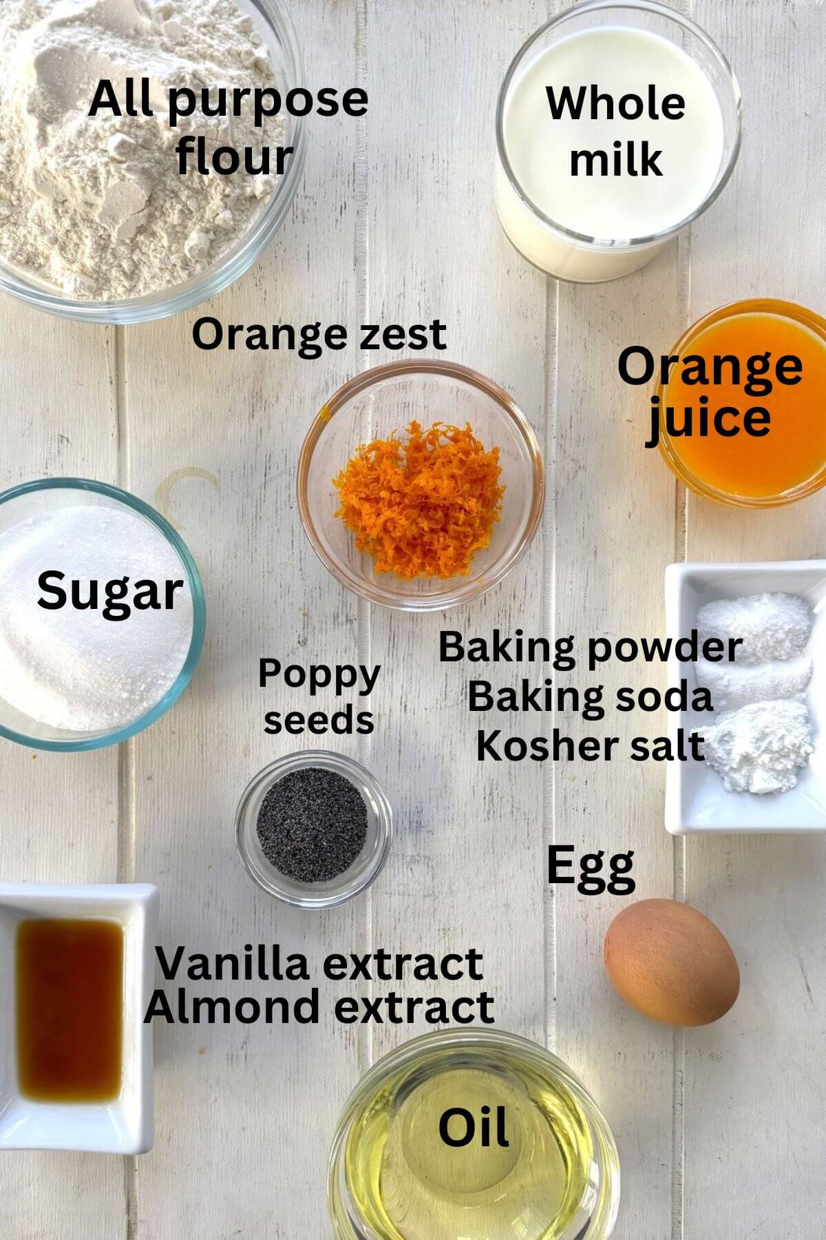 Flour, sugar, orange juice, zest, egg, milk, baking powder, kosher salt on a white board.