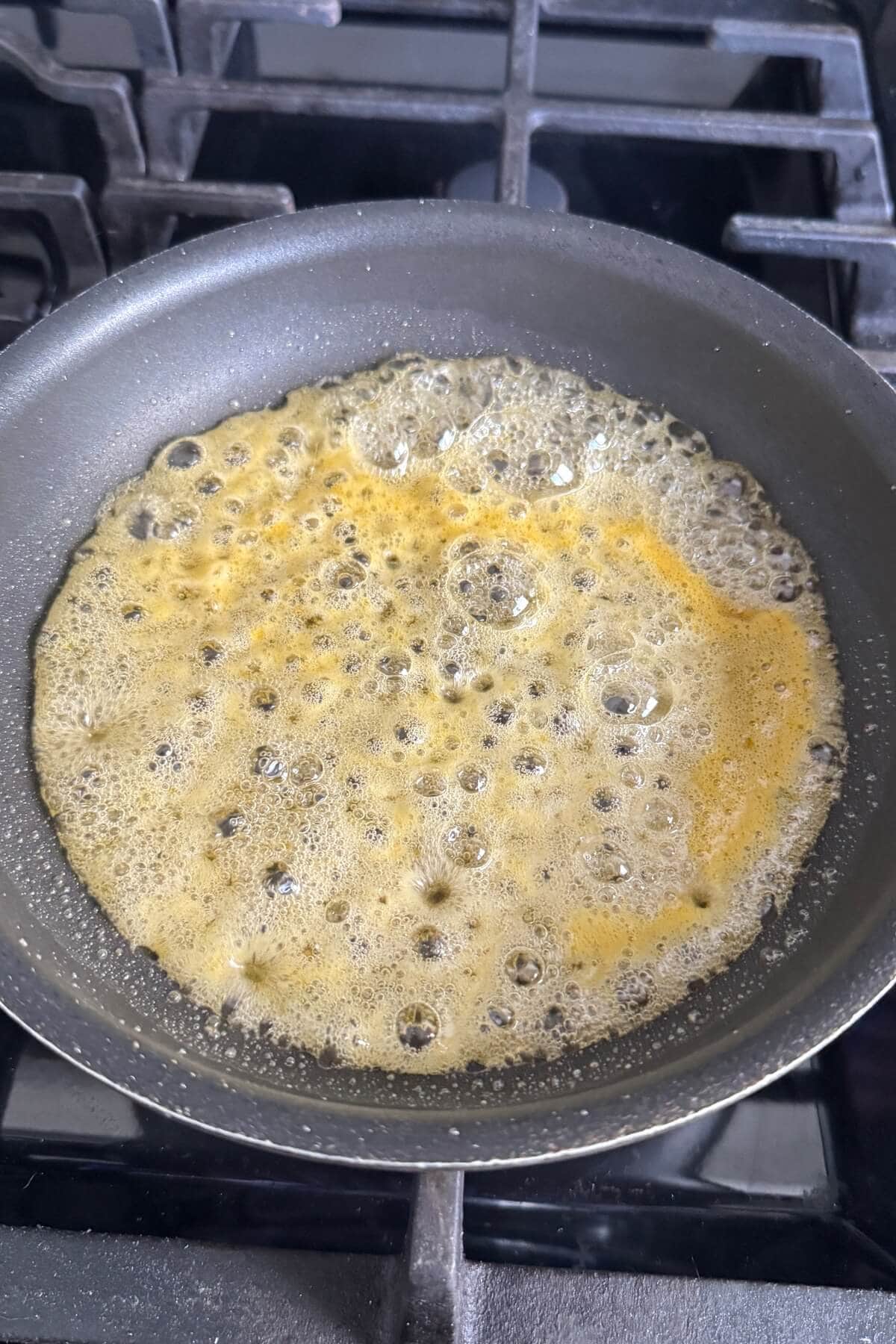 Bubbling orange glaze in a pan.