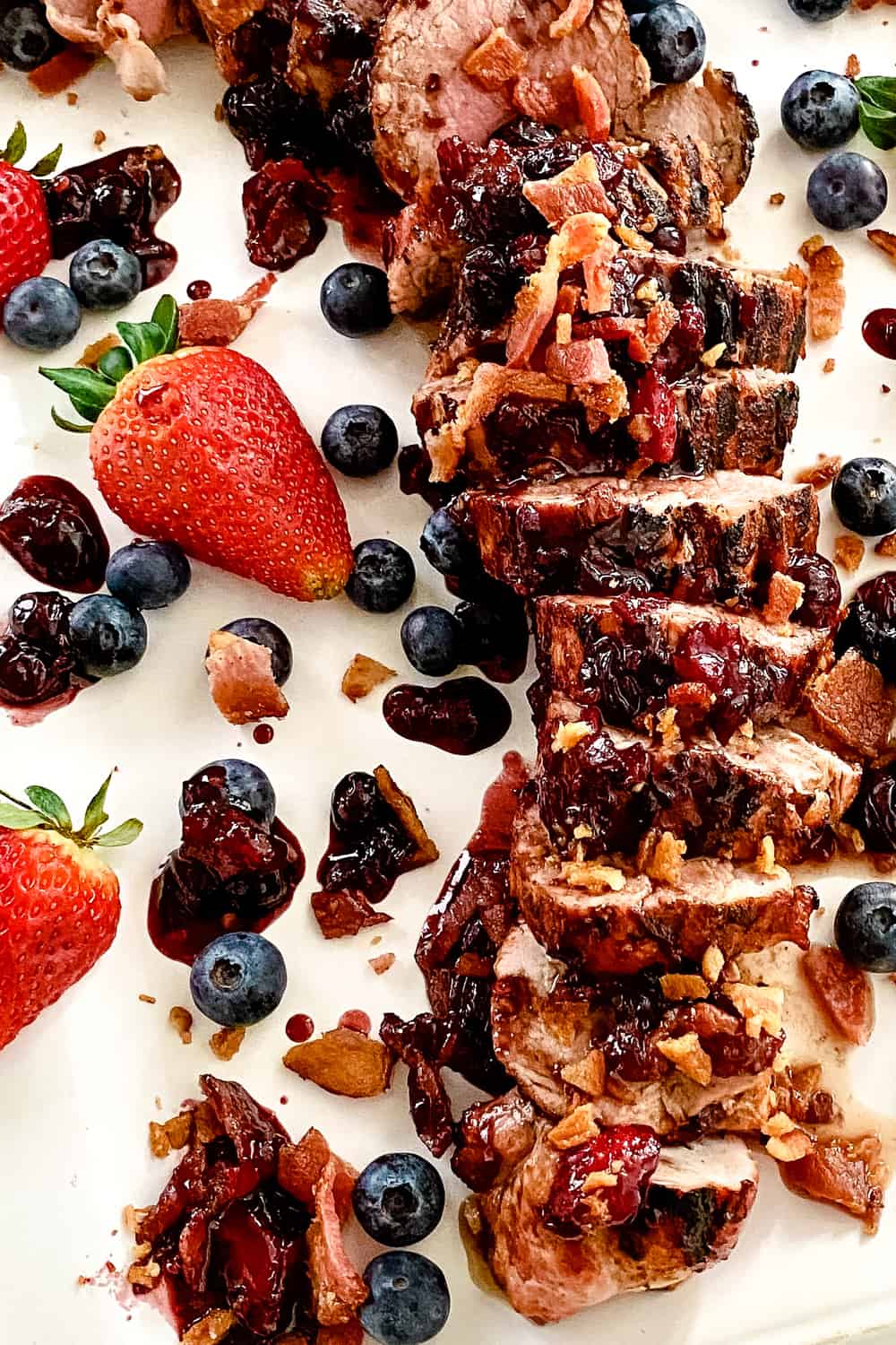 sliced grilled pork tenderloin with berry bacon sauce