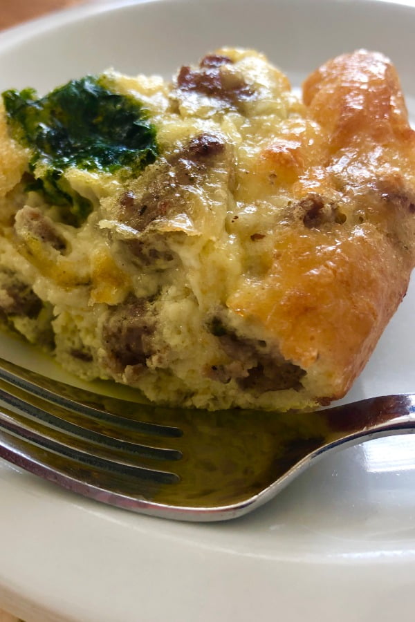 slice of breakfast casserole with sausage and cheese