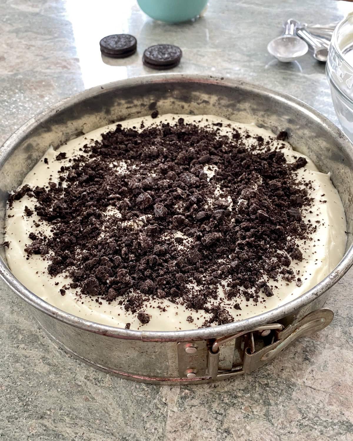 Oreo crumbs sprinkled over batter in pan.