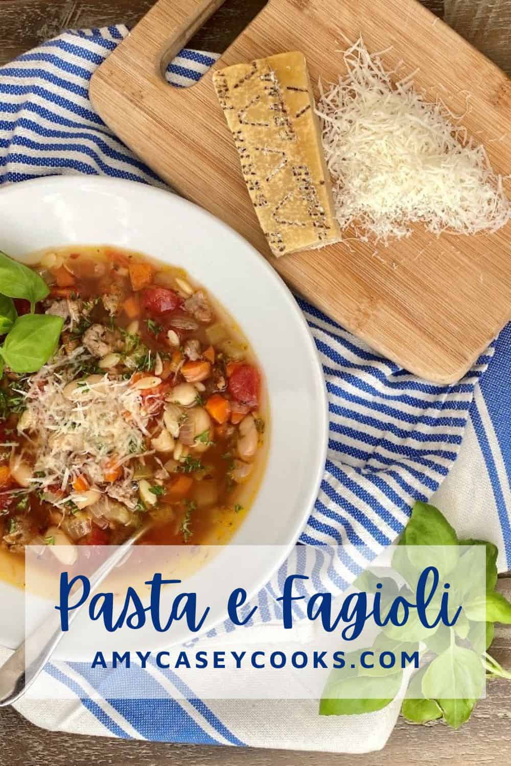 bowl of pasta e fagioli with shredded Parmesan cheese