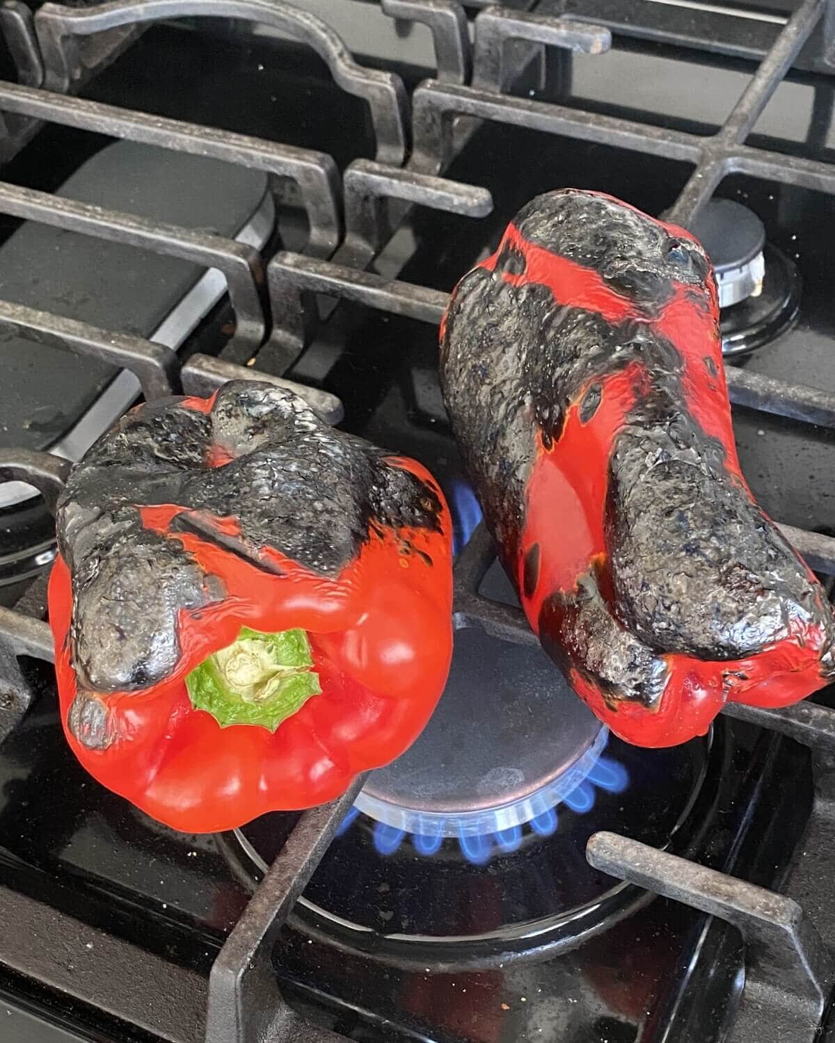 Roasting red peppers over a gas flame.