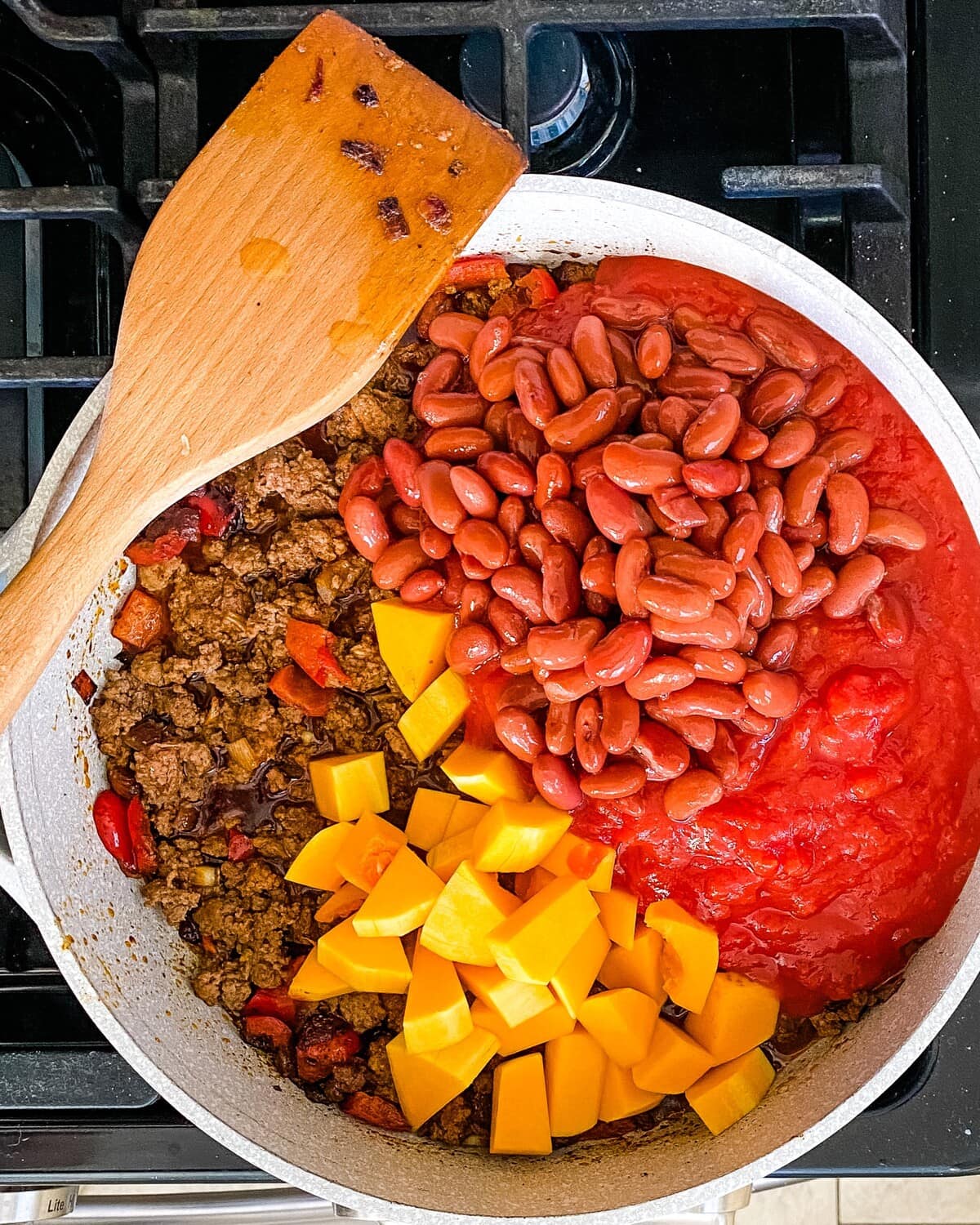 Beans, canned tomatoes and butternut squash added to the pot.