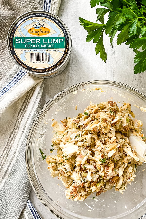 can of crab and ingredients in bowl for crab cakes.