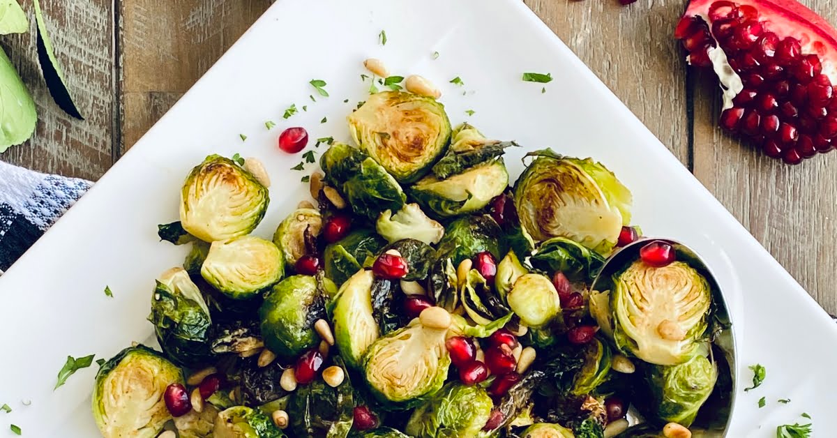 platter of roasted Brussels sprouts with pomegranate and pine nuts