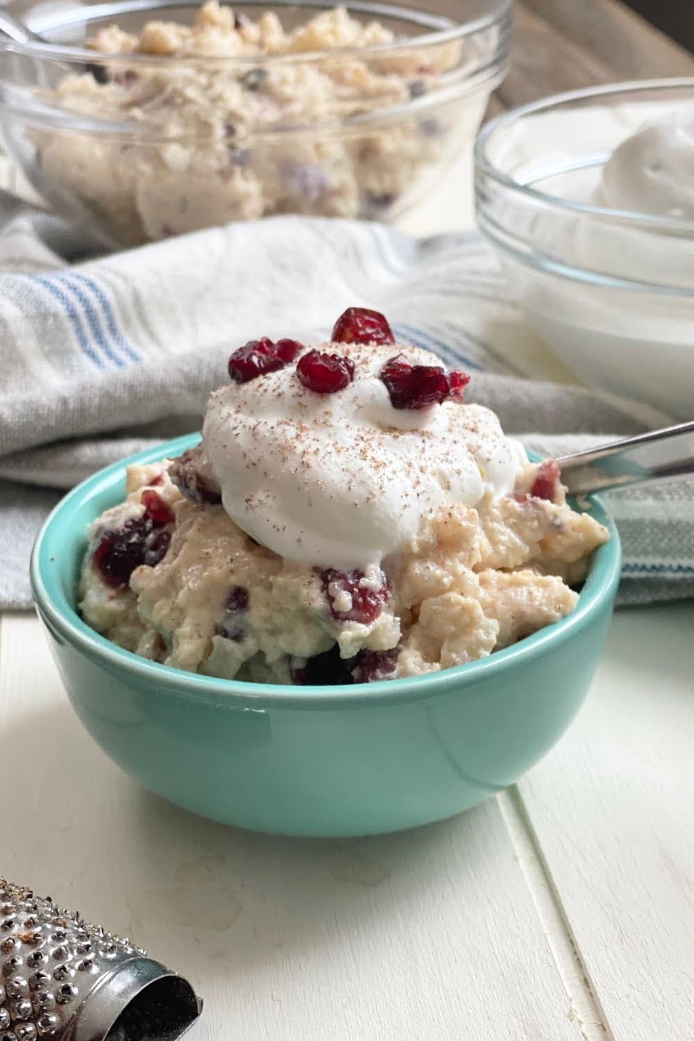 creamy bowl of stovetop rice pudding with whipped fresh cream