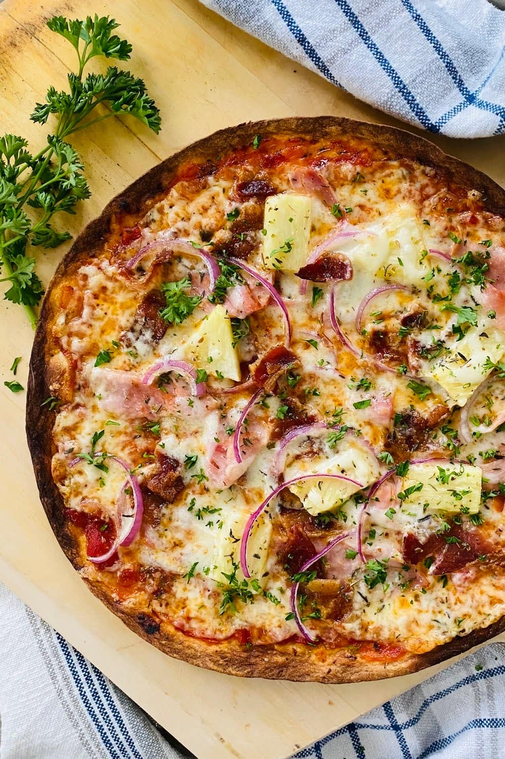 a quick snack on a thin flour crust with ham, pineapple and bacon