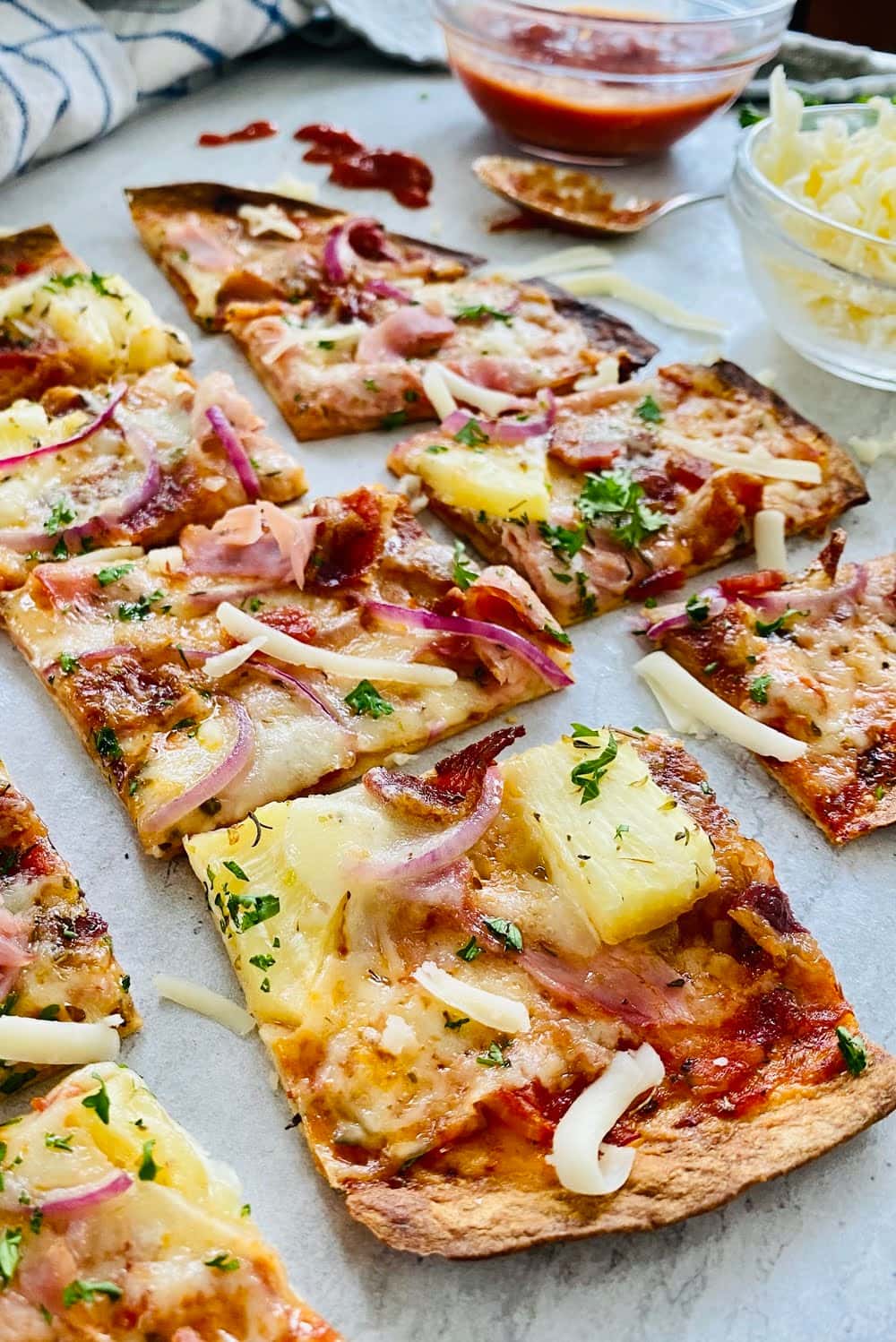 slices of thin flour crust with ham-bacon and pineapple.