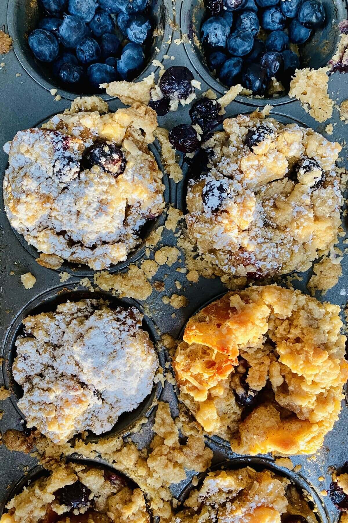 blueberries and muffins in a pan.