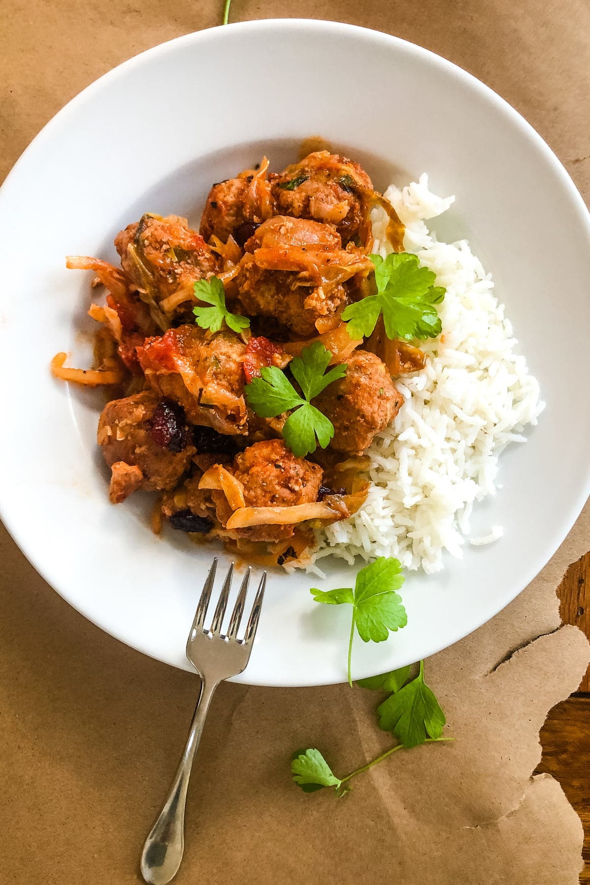 a bowl of cabbage roll meatballs over rice
