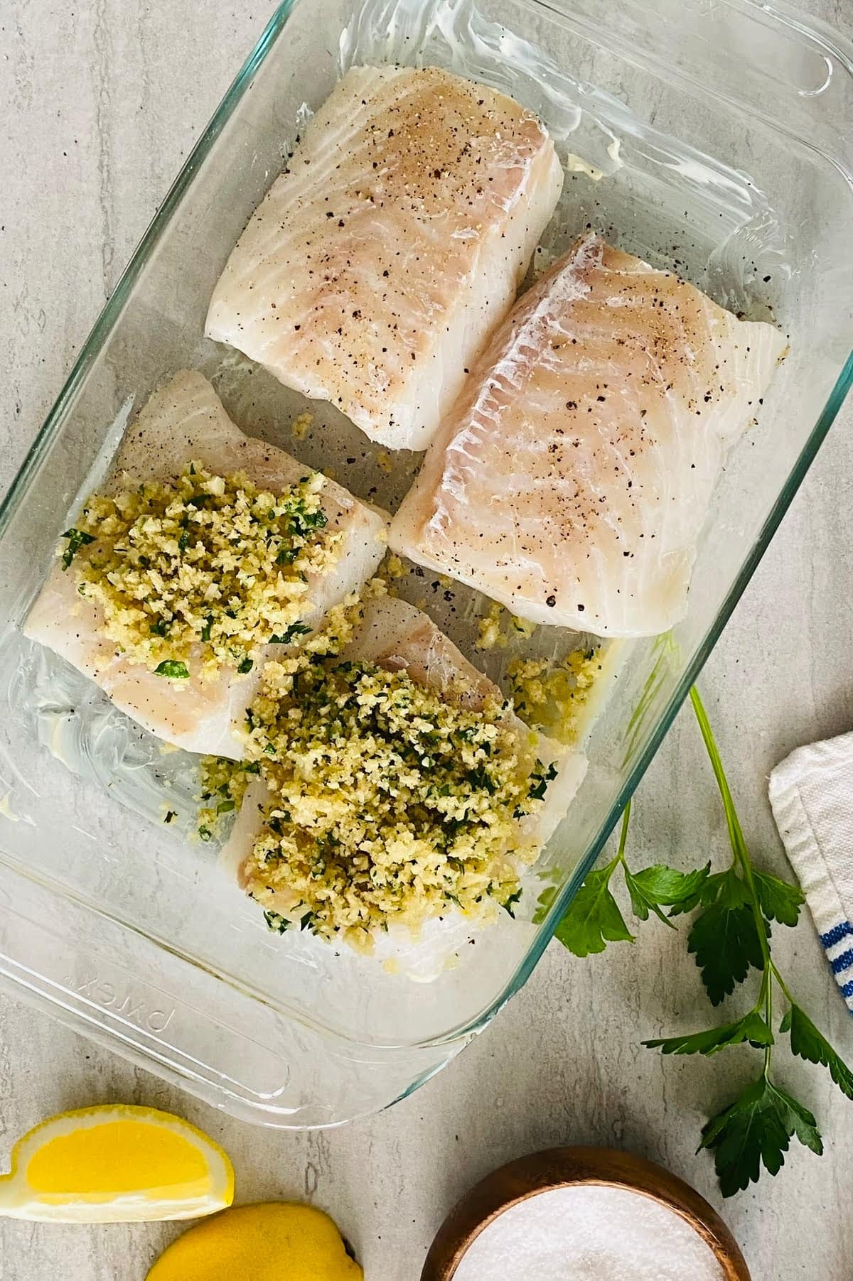 2 unbaked cod filets topped with garlic butter and herb panko.