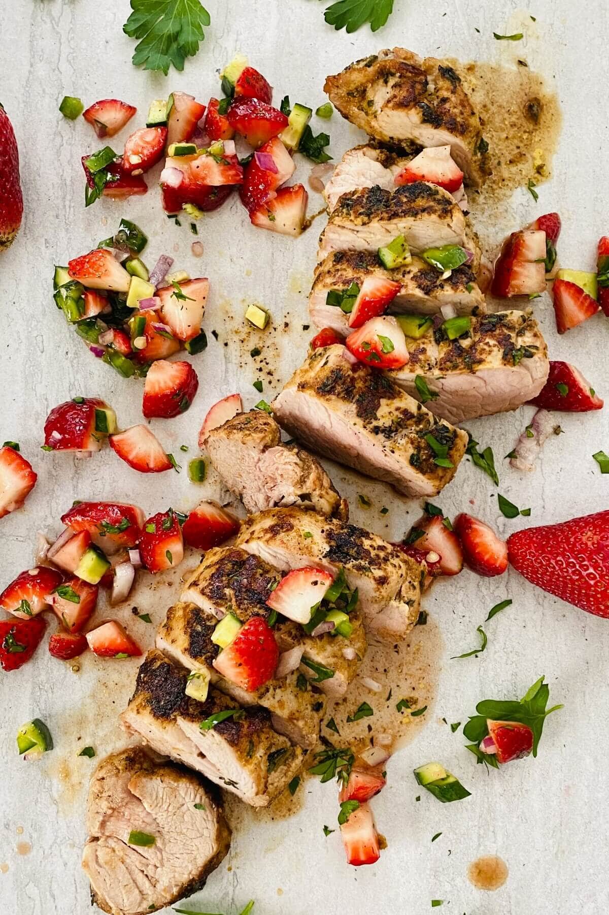 sliced pork tenderloin with strawberries.