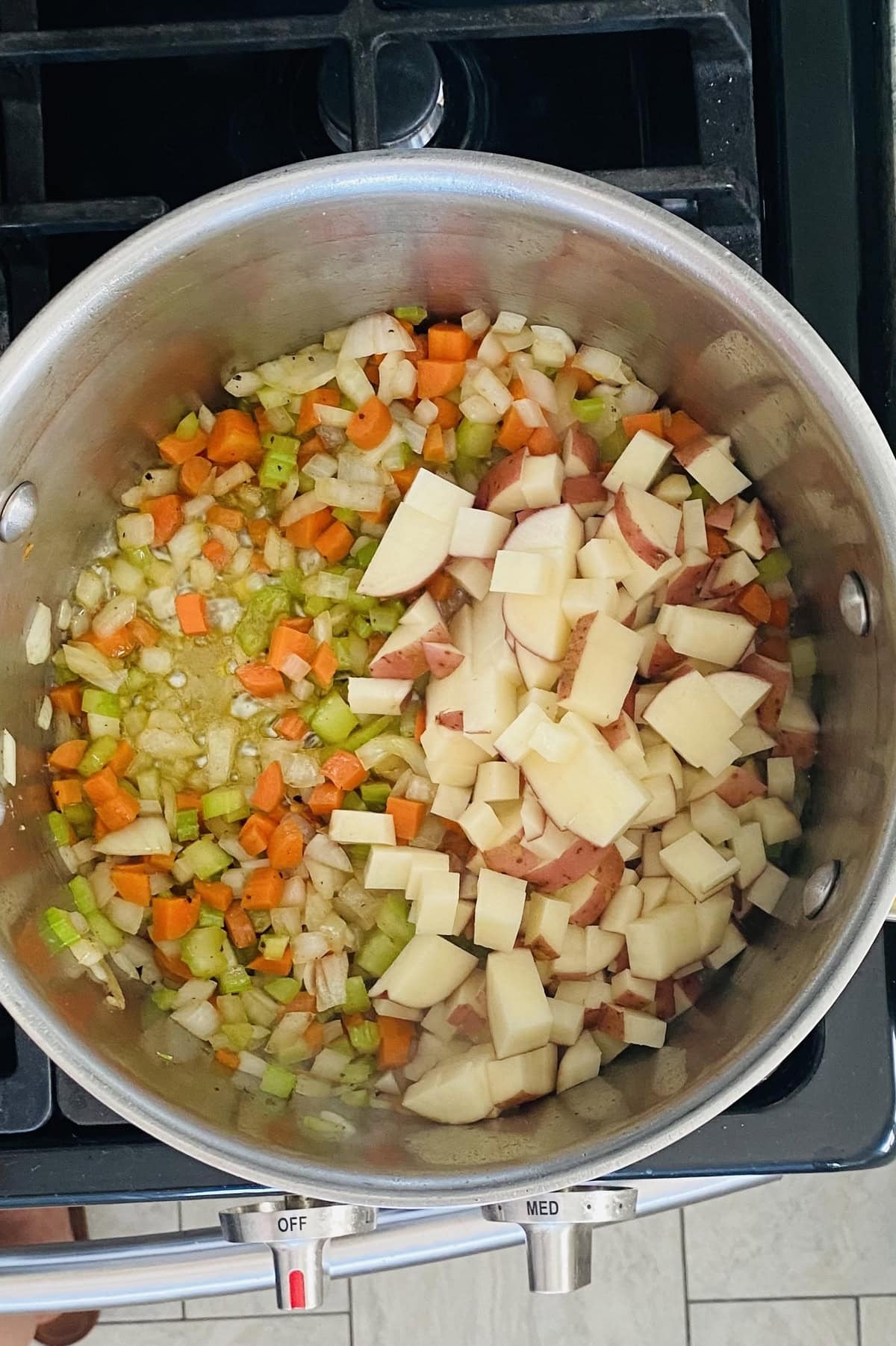 Sautéing vegetables for Manhattan clam chowder.