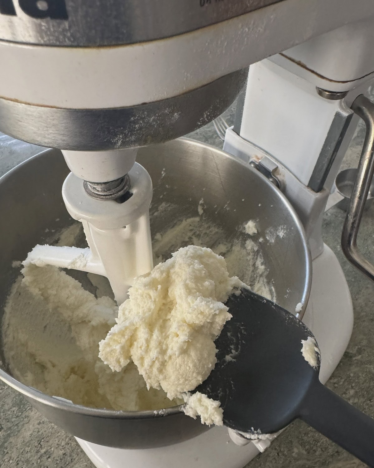 A spatula with creamed butter and sugar.