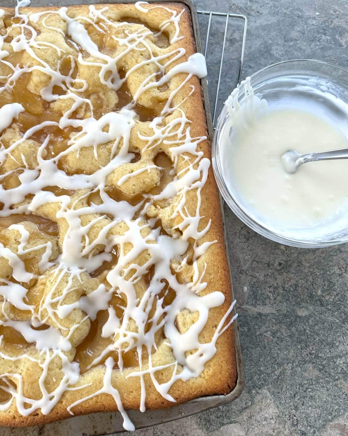 A scone cake with a bowl of frosting.
