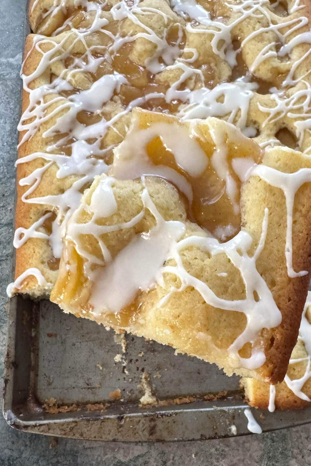 A slice of apple scone cake on a spatula.