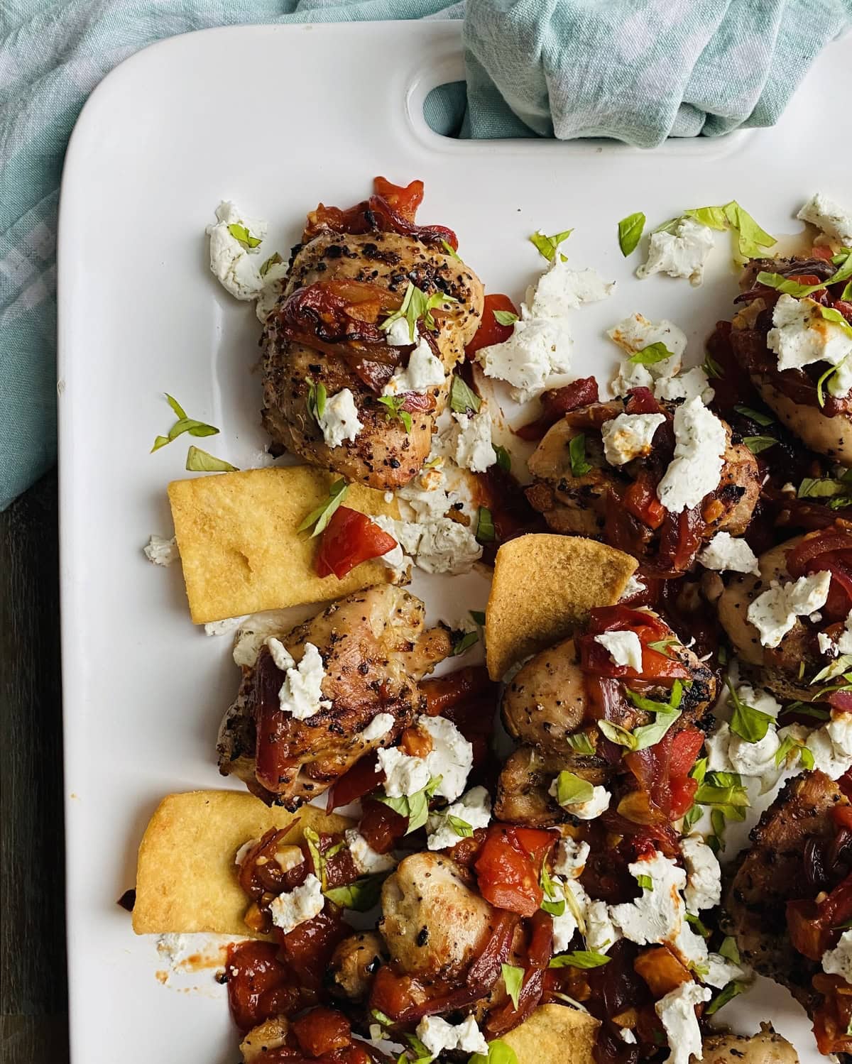 platter with grilled chicken thighs and bruschetta
