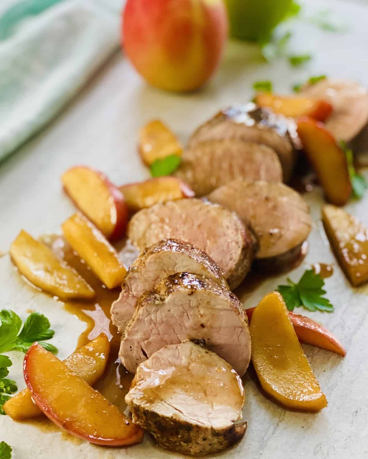 Seared and sliced pork tenderloin with sautéed apples.