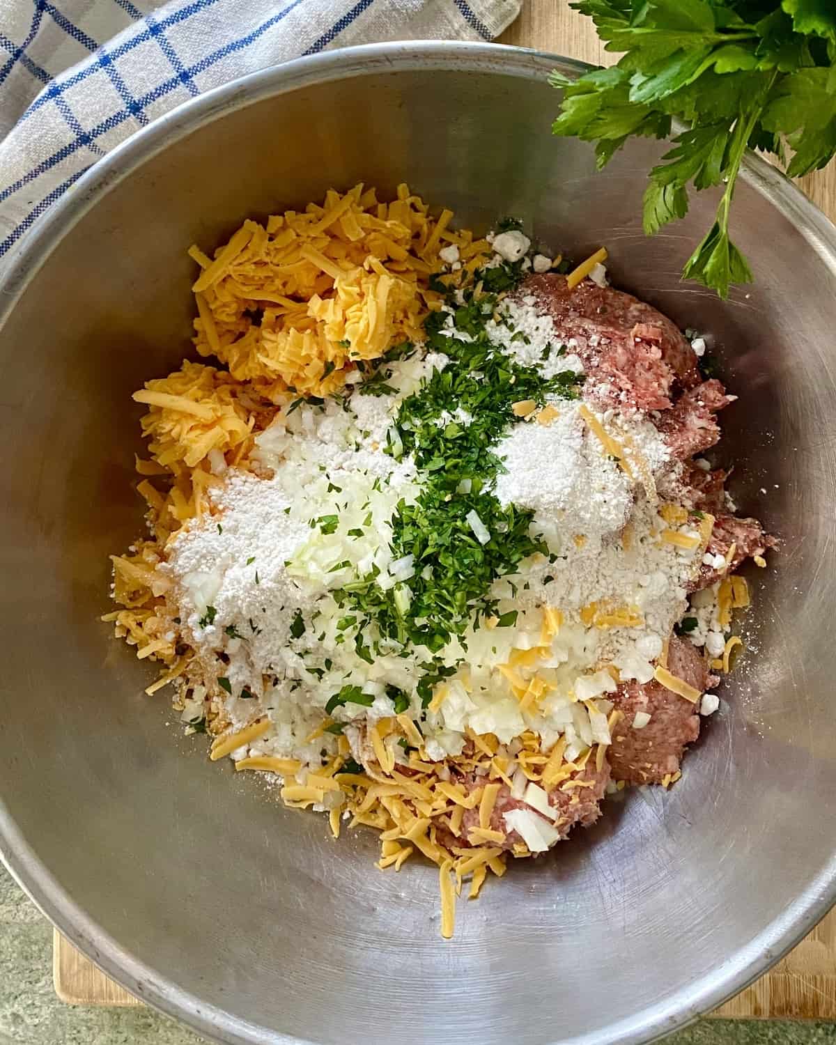 A bowl with the ingredients for sausage and cheese balls.