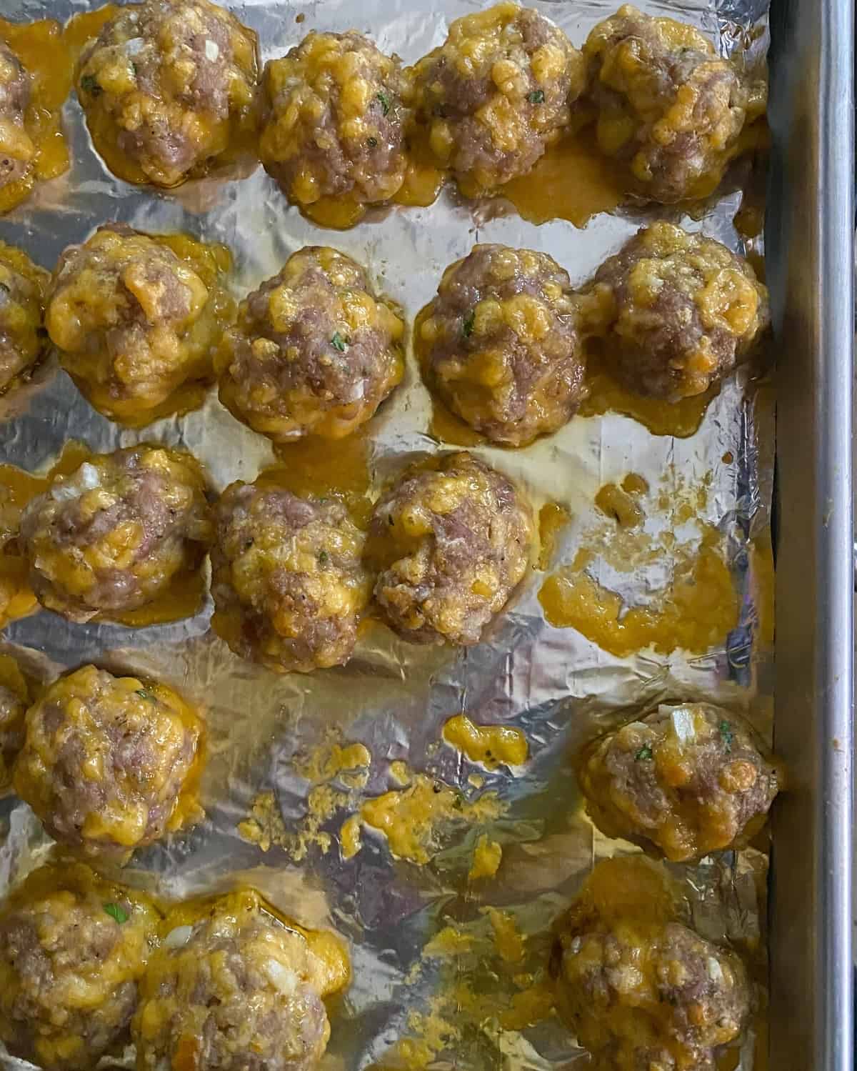 baked sausage balls on a baking sheet