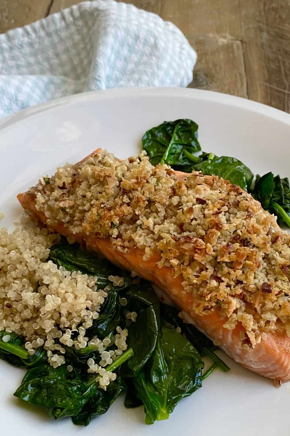 Salmon crusted with pecan panko with spinach.
