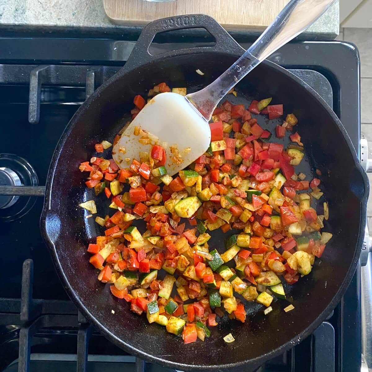 Sauteed vegetables in a cast iron skillet.