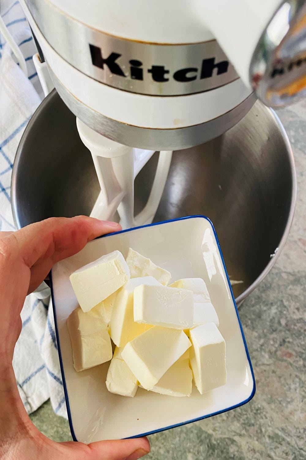 adding cream cheese to mixer