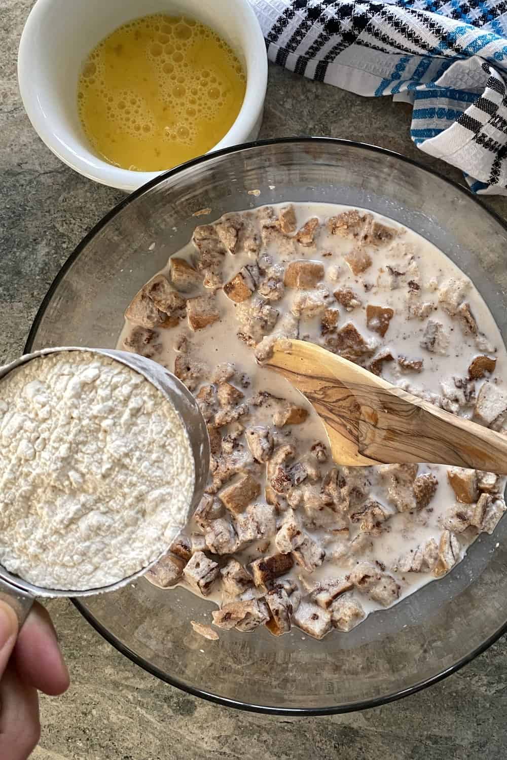 bowl with pancake ingredients and adding flour