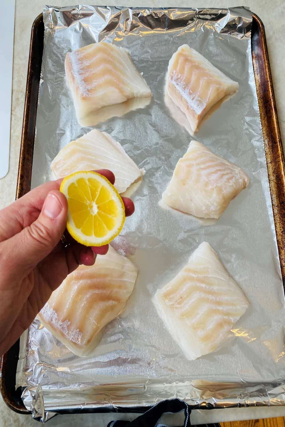Squeezing lemon juice over fish.