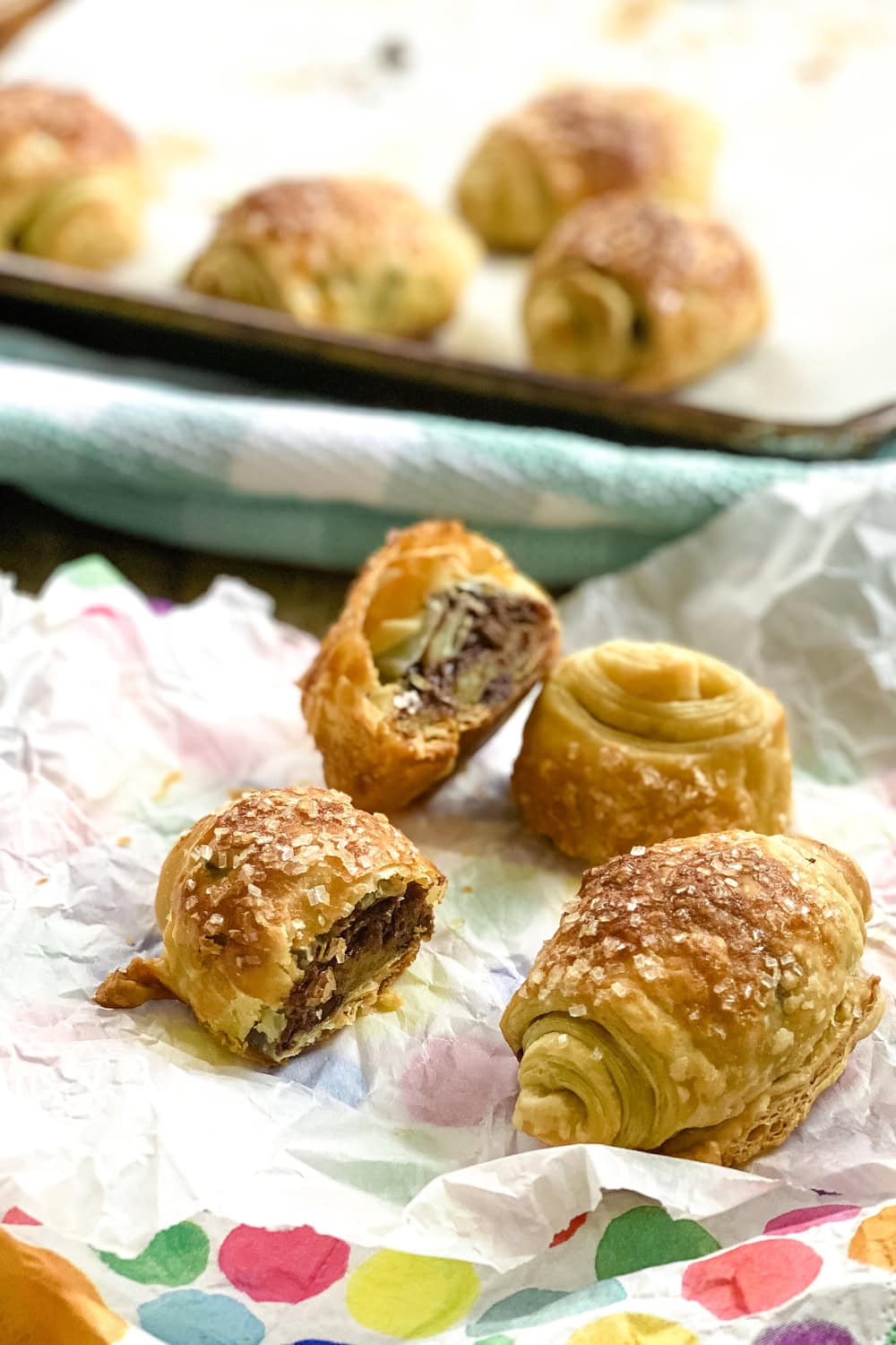 a baking sheet with chocolate puff pastry and a serving plate