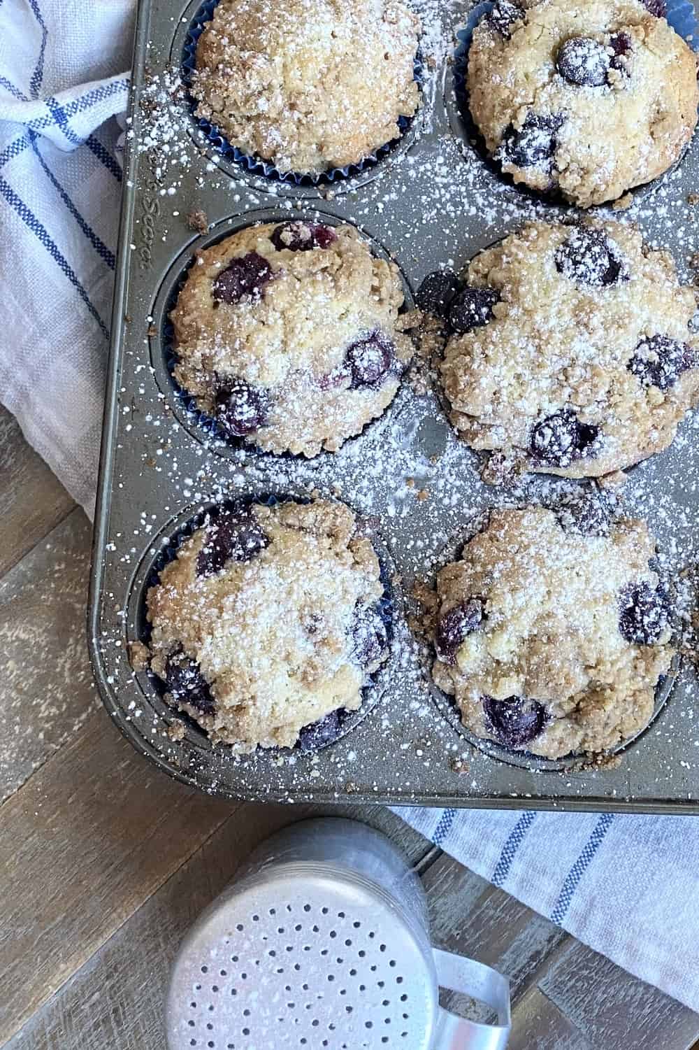 A baking pan with blueberry muffins.