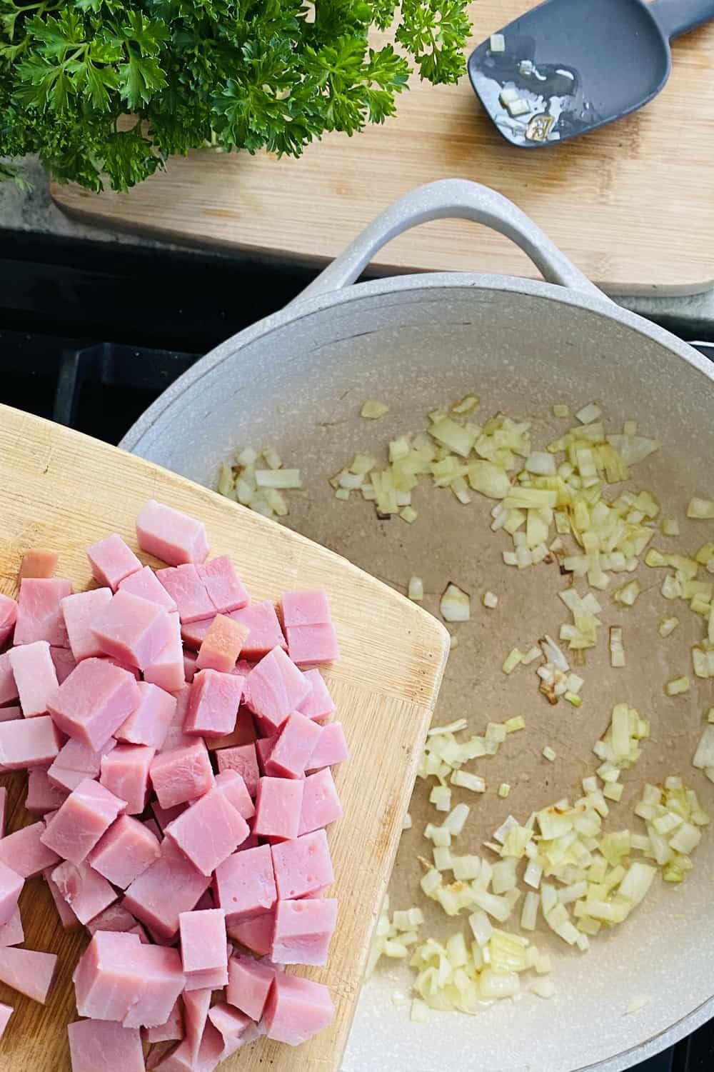 adding ham to a sauté pan