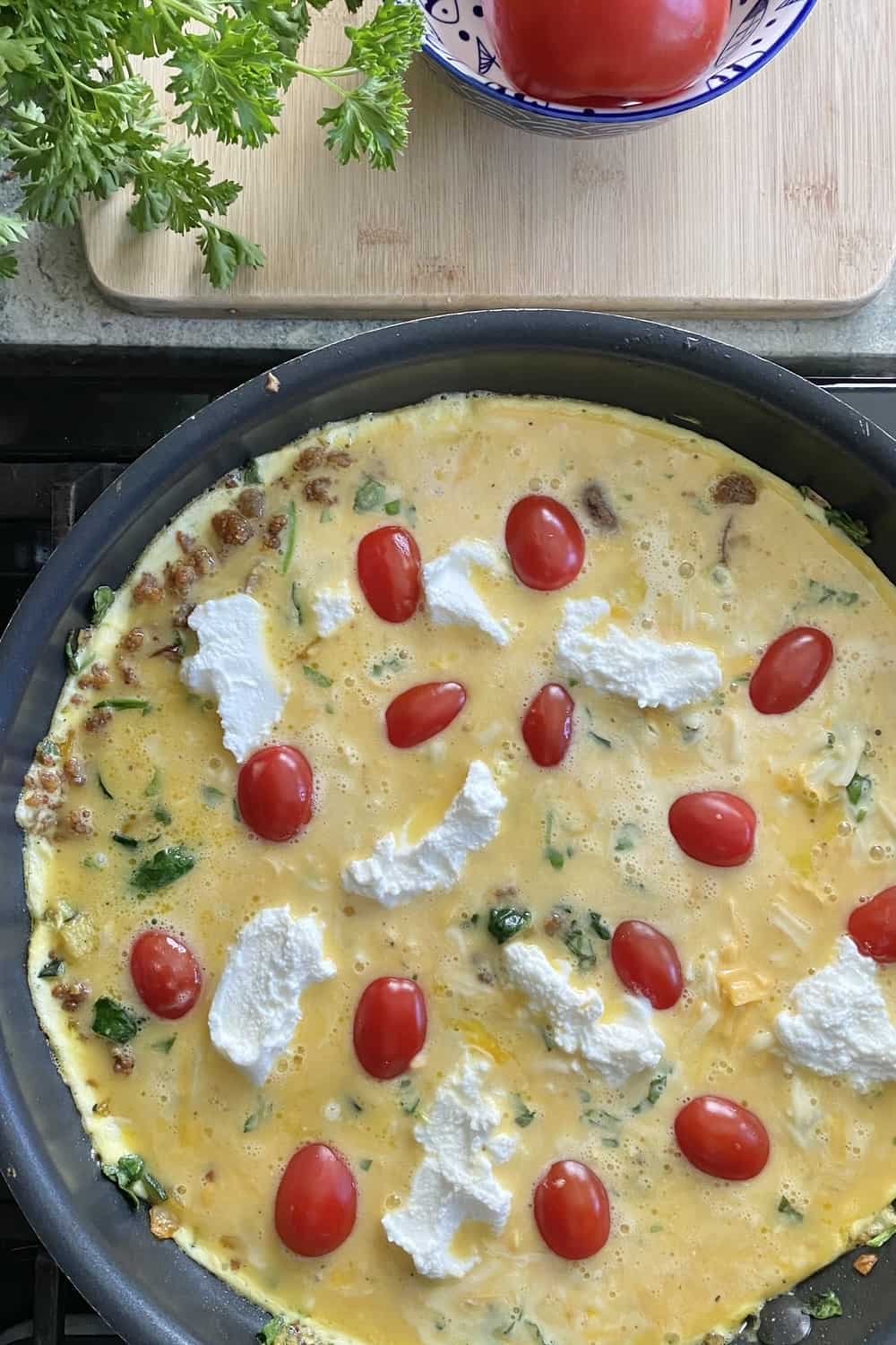 An unbaked frittata on a non stick pan.