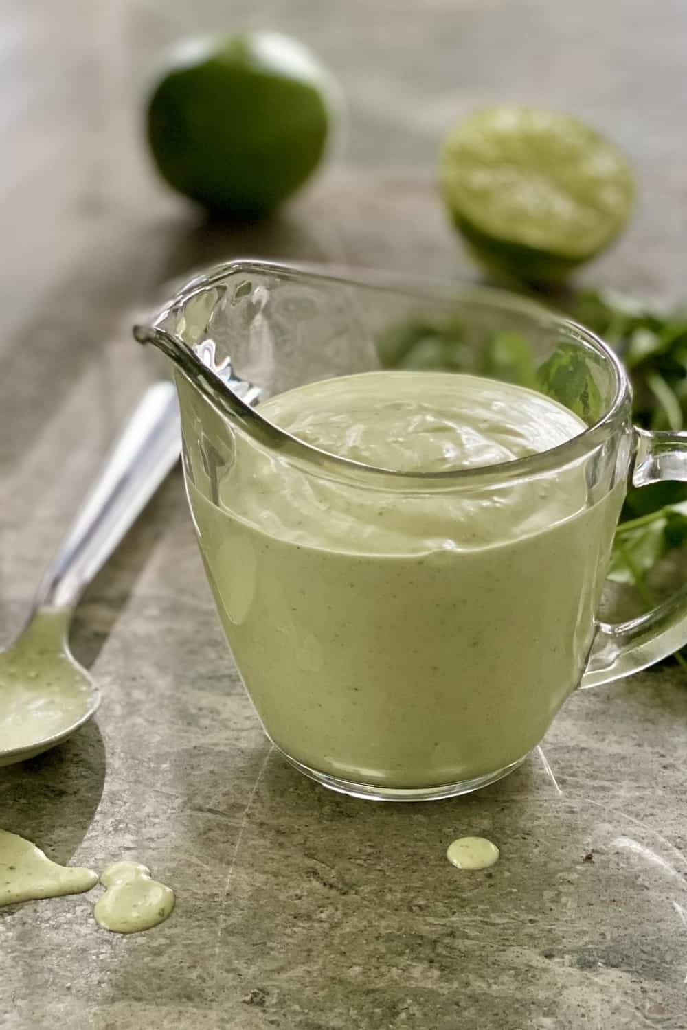 A glass pitcher with creamy cilantro dressing.