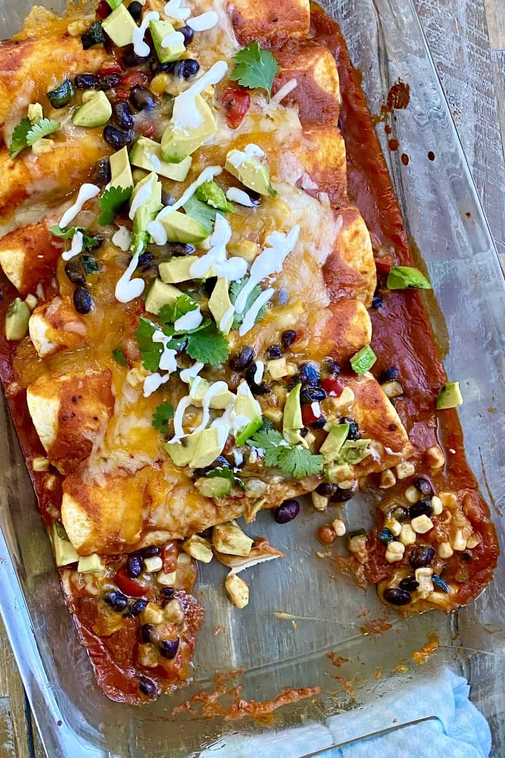 A baking dish with vegetable and bean enchiladas.