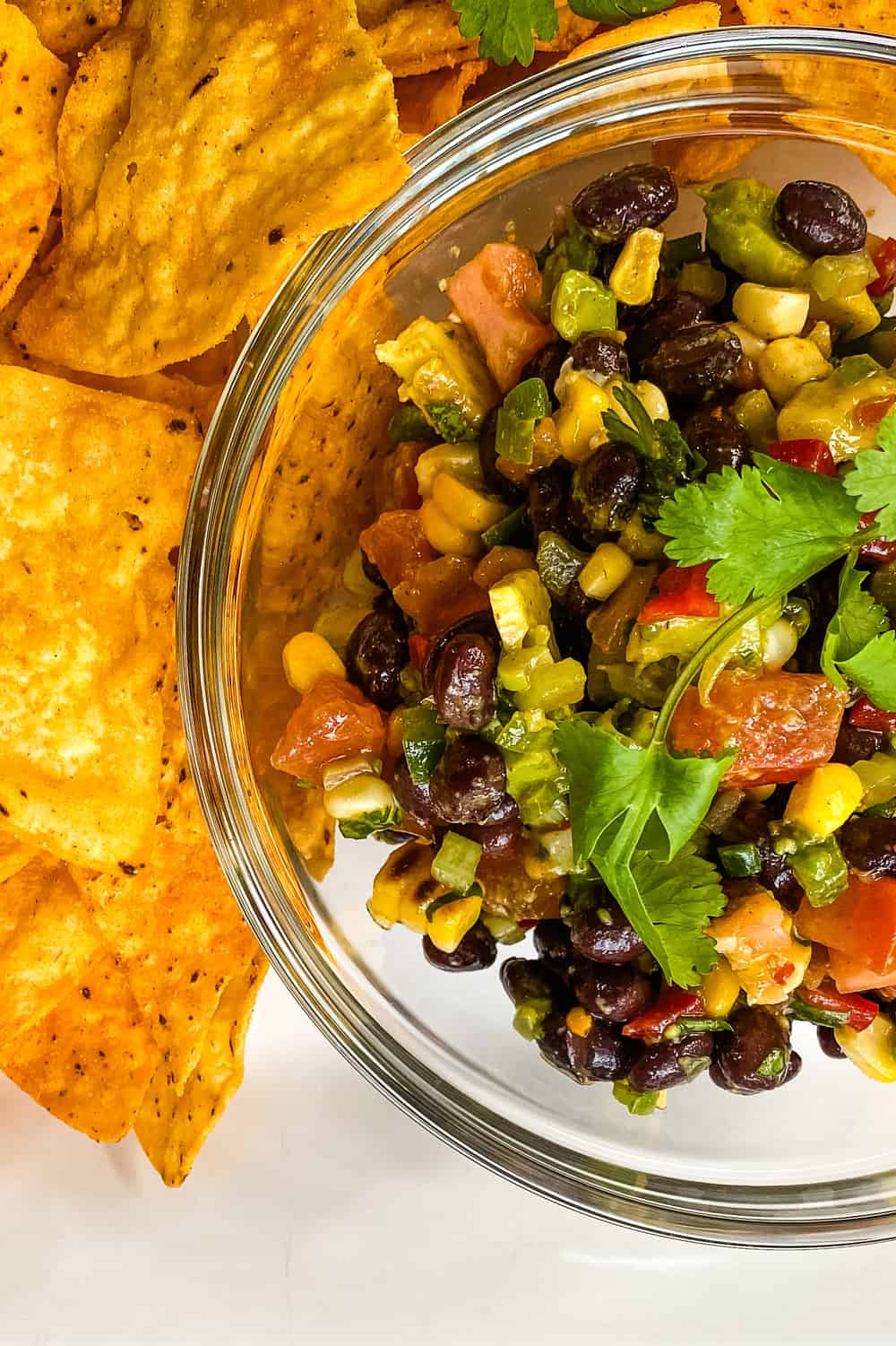 A bowl of Texas caviar with tortilla chips.