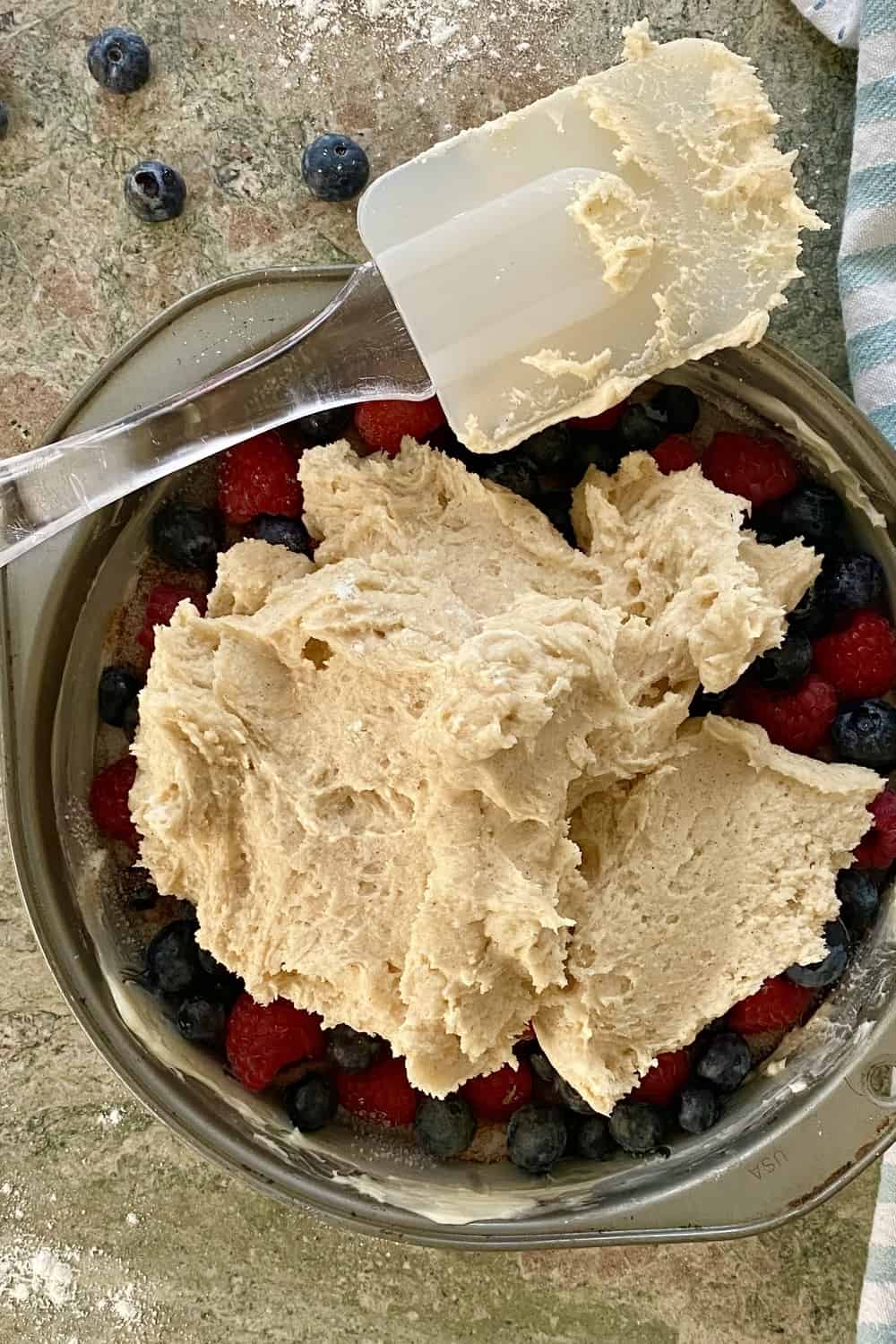 adding batter to berry cake.