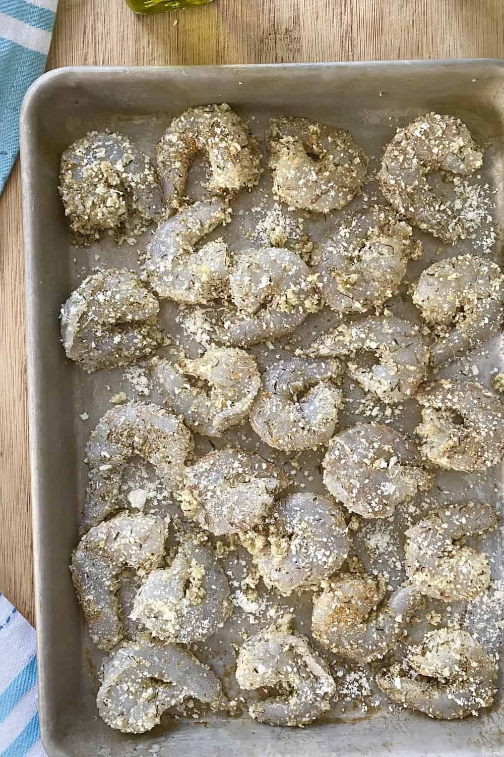 Seasoned shrimp on a baking sheet.