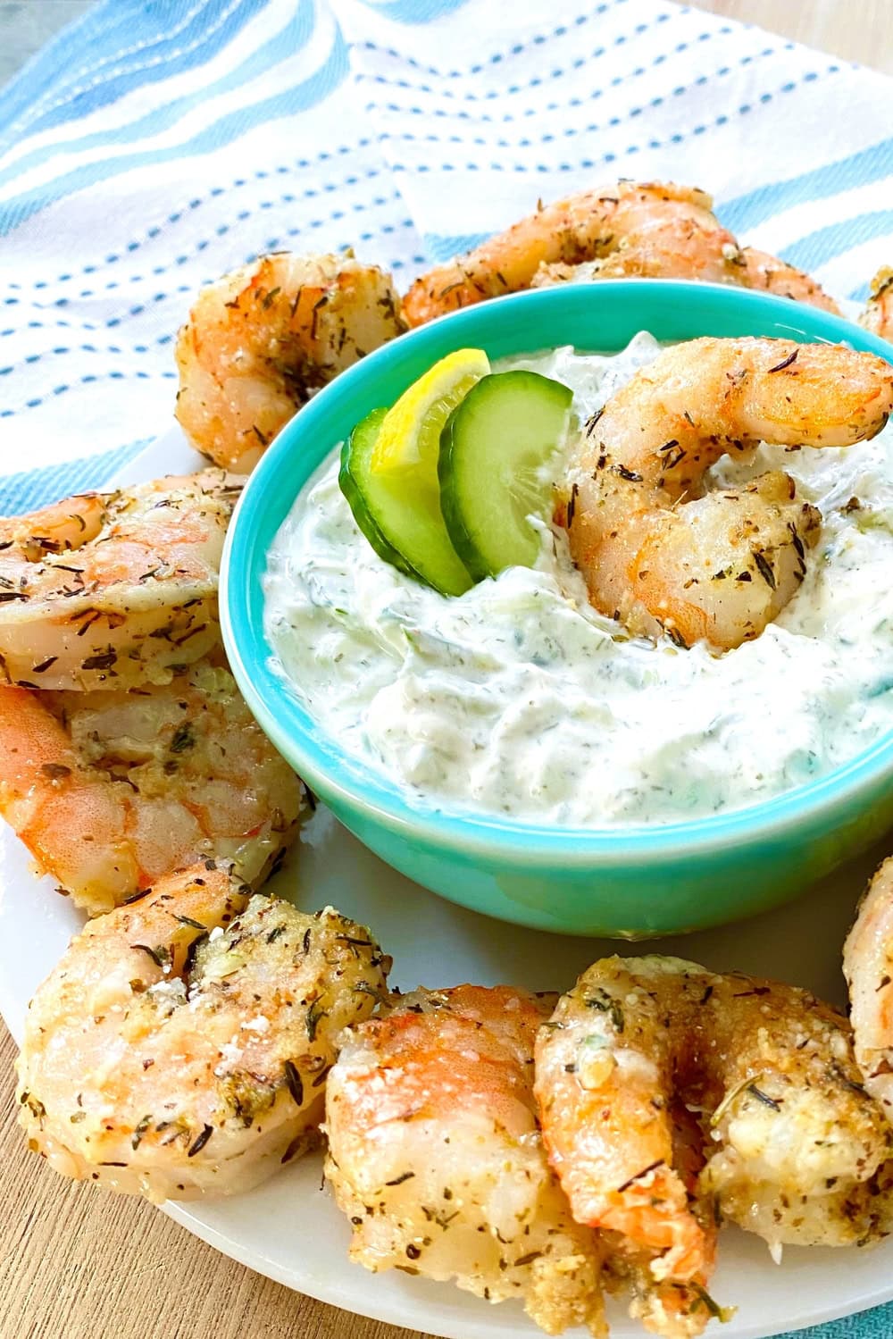 A bowl of tzatziki sauce with shrimp.
