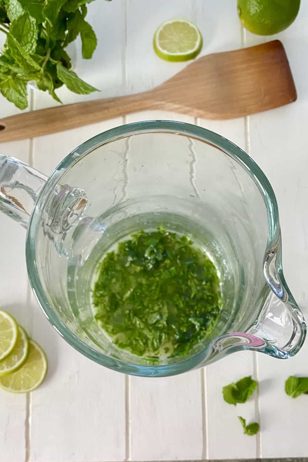 muddled mint leaves in a pitcher